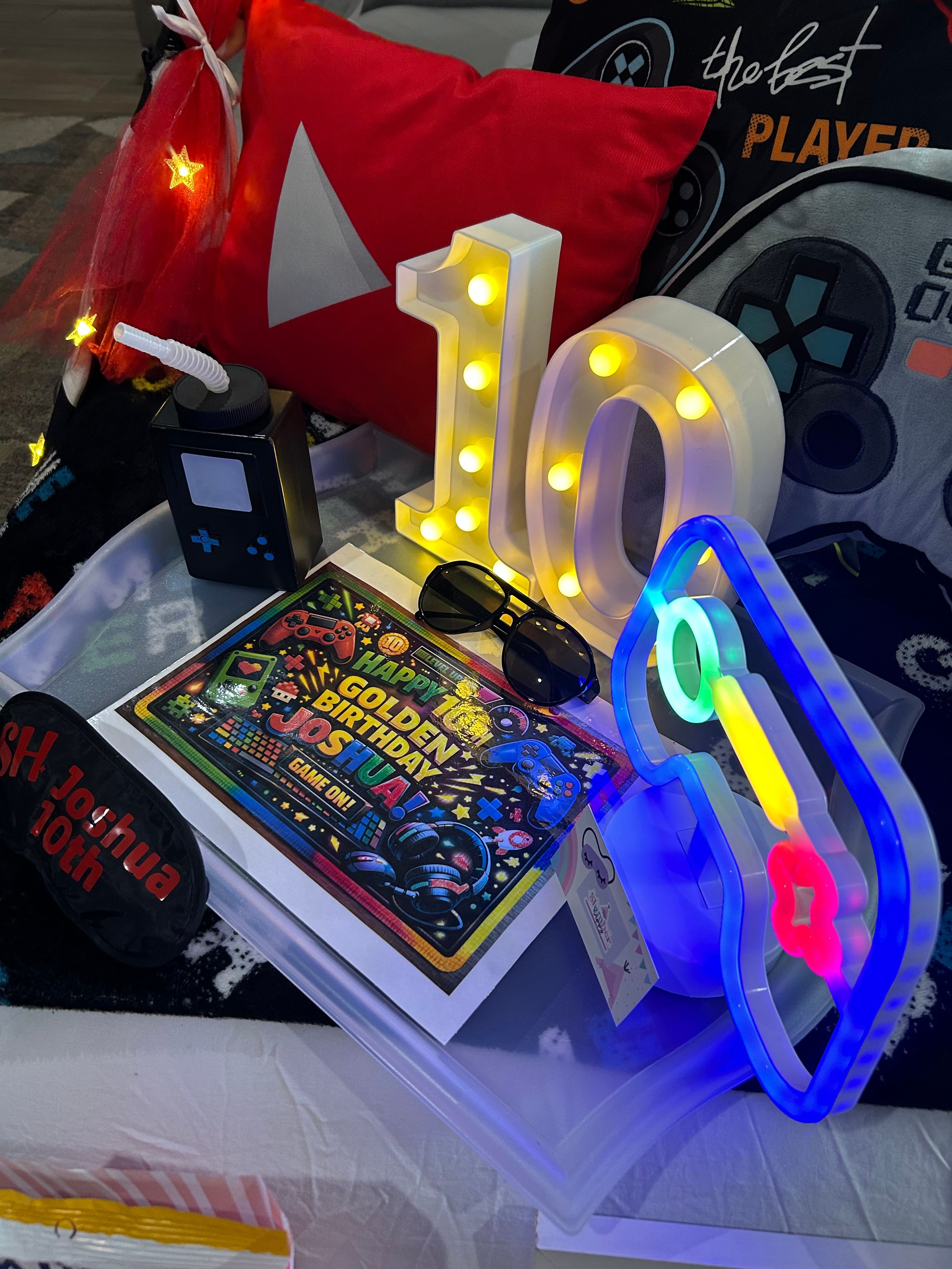 Decorative illuminated number ten, colorful gaming magazine, and various gaming accessories on a table.