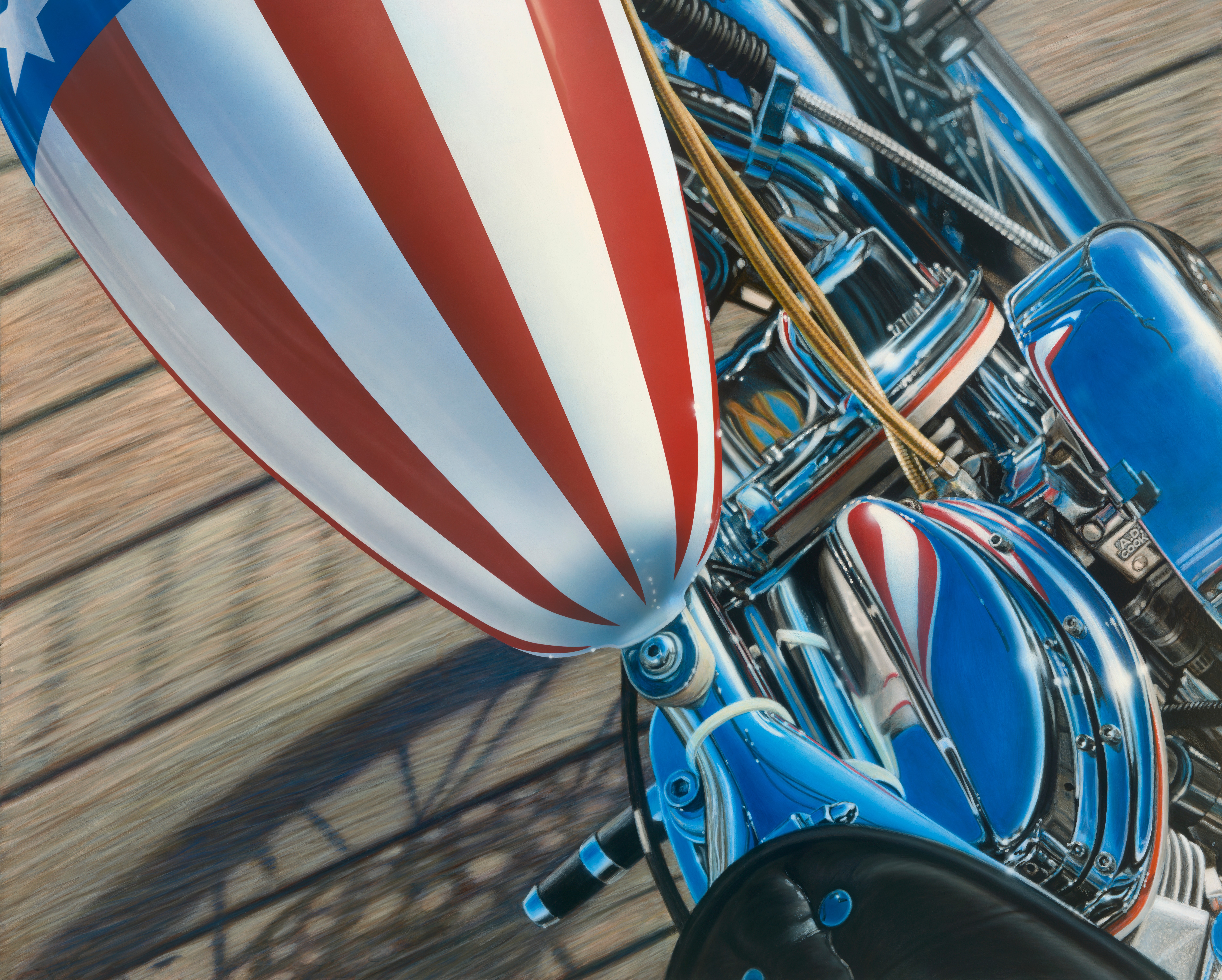 Close-up of a blue motorcycle with a red and white striped balloon attached, moving on a track.