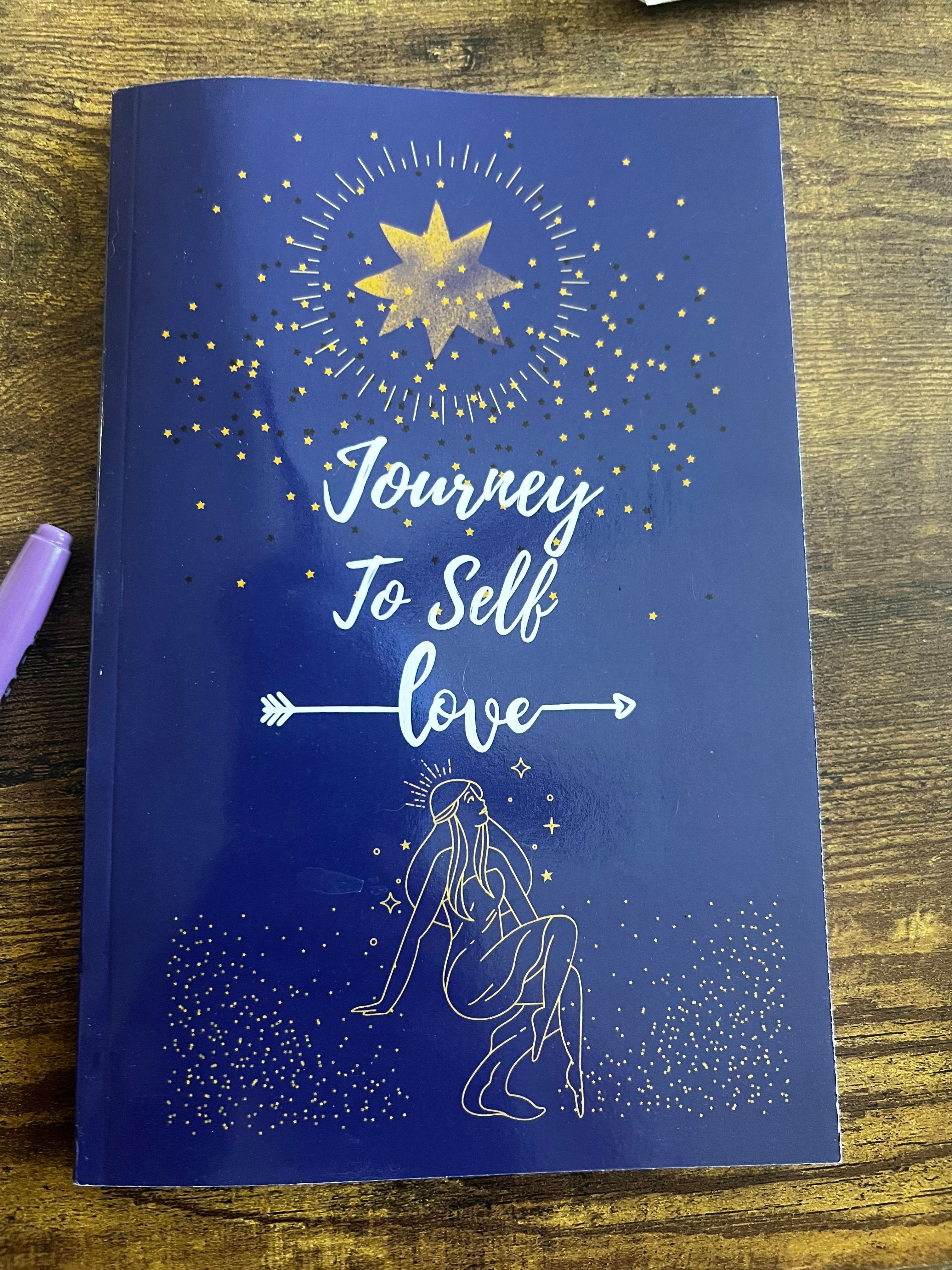 Blue book cover with white text and illustrations, including a star, arrow, and a person riding a horse, on a wooden surface.