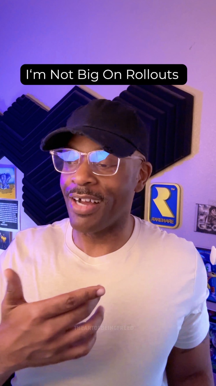 Person wearing glasses and a cap, smiling, pointing at themselves, with a colorful background and a sign that says 'I'm Not Big On Rollouts'.