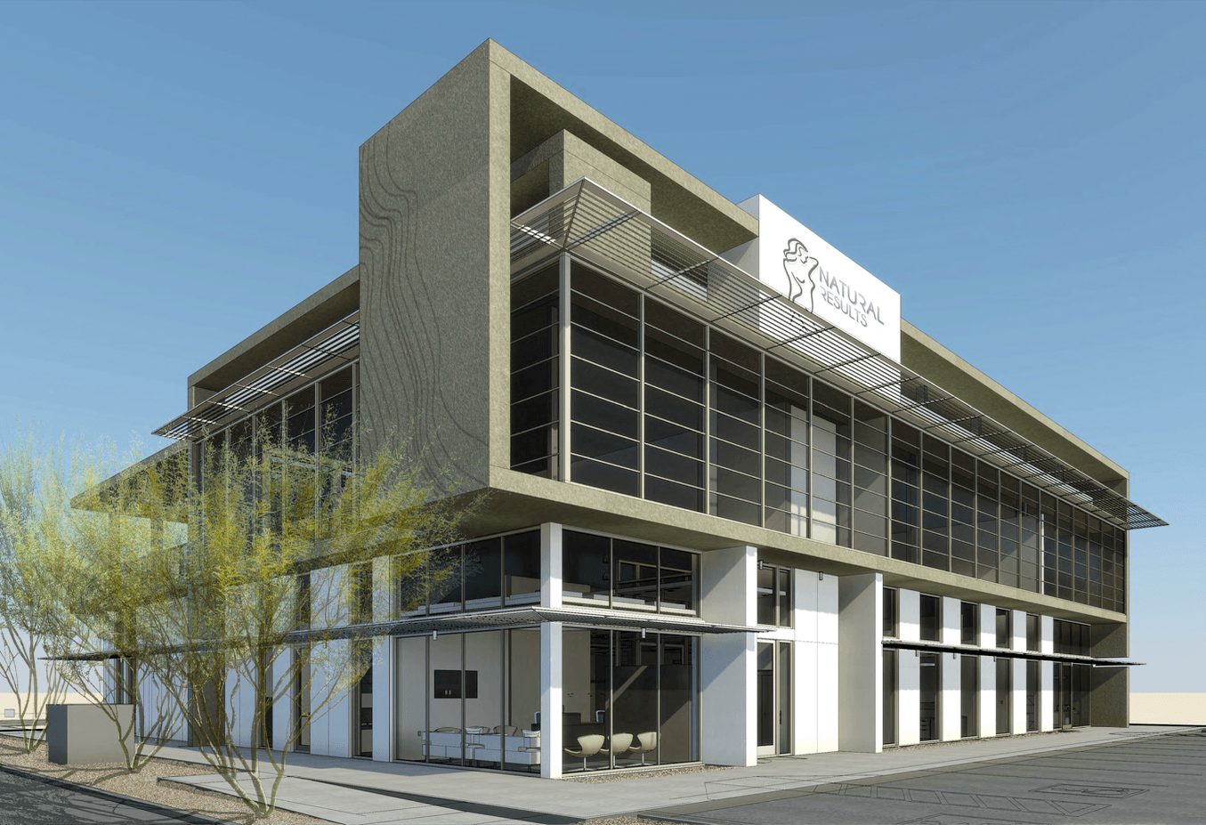 Modern multi-story building with glass windows and a sign on top, against a clear blue sky.