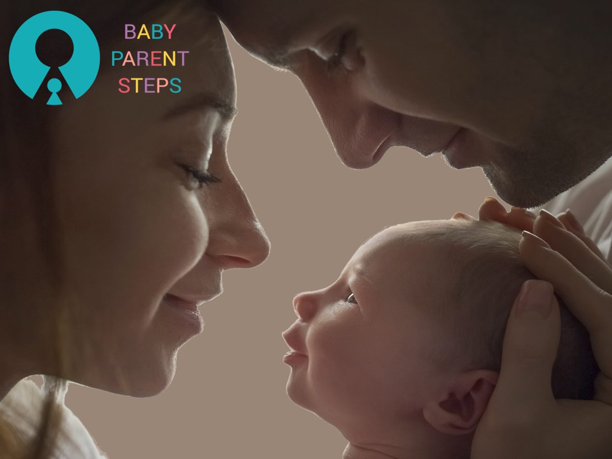 Adult and baby face close, touching noses, with a logo and text in the top left corner, neutral background.